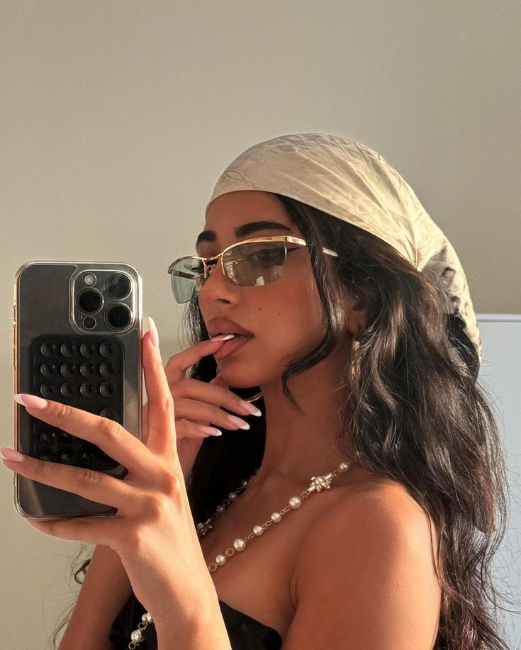 Cream silk headscarf in a mirror selfie.