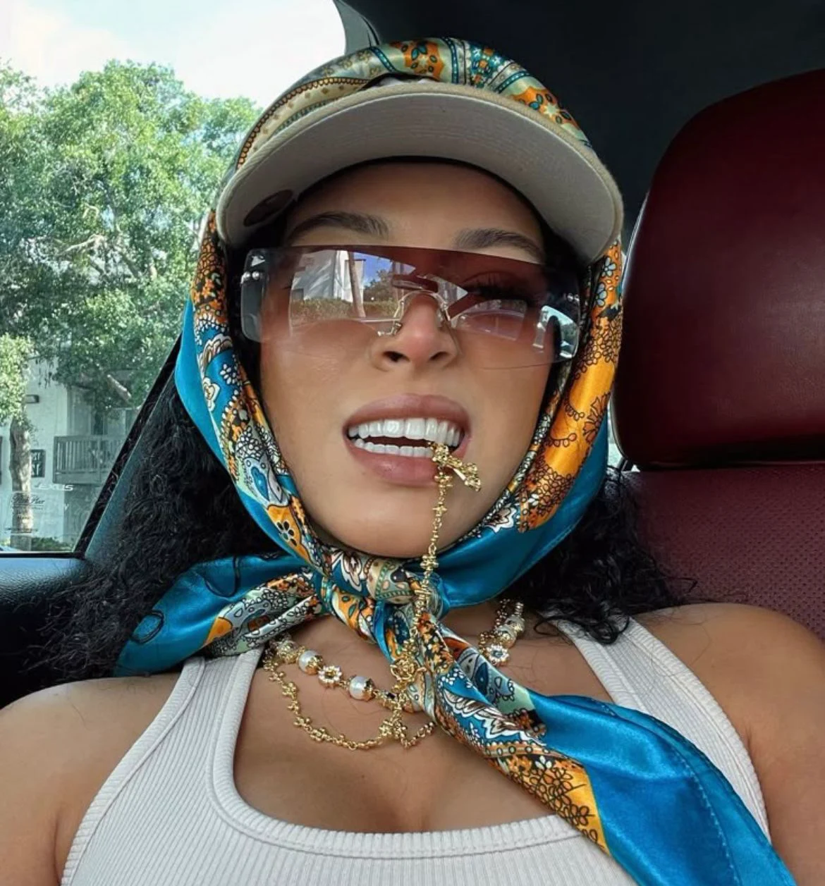 Teal paisley silk wrapped under a cap, in the car.